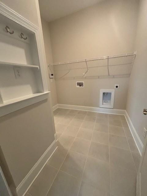 washroom featuring electric dryer hookup, baseboards, washer hookup, and light tile patterned flooring