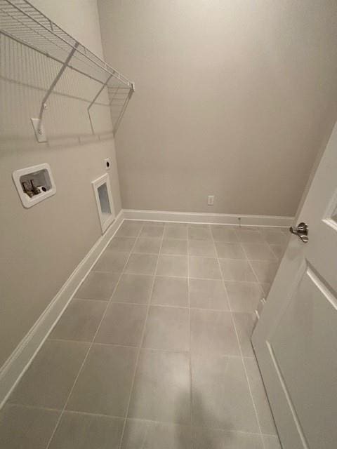laundry area with hookup for a washing machine, baseboards, tile patterned floors, and hookup for an electric dryer