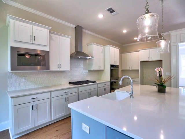 3730 Reserve Overlook Way, Cumming, GA 30041 - kitchen featuring wall chimney exhaust hood, a sink, black gas cooktop, light wood finished floors, and crown molding