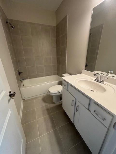 bathroom featuring tile patterned floors, vanity, tub / shower combination, and toilet