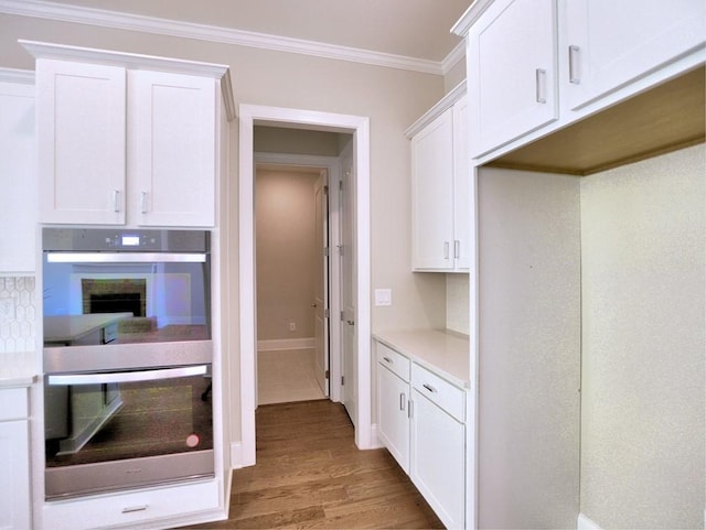3730 Reserve Overlook Way, Cumming, GA 30041 - kitchen featuring double oven, white cabinets, wood finished floors, crown molding, and light countertops