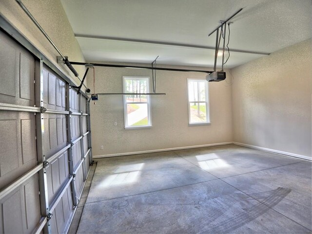 3730 Reserve Overlook Way, Cumming, GA 30041 - garage with a garage door opener, a textured wall, and baseboards