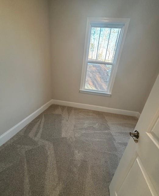 empty room with carpet flooring and baseboards