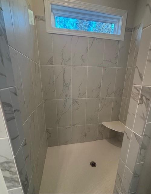 full bathroom with tiled shower