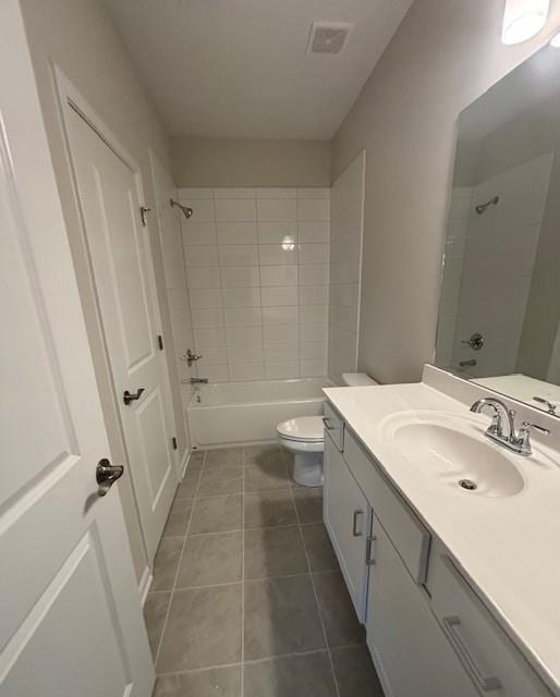 bathroom featuring toilet, tile patterned flooring, bathing tub / shower combination, and vanity