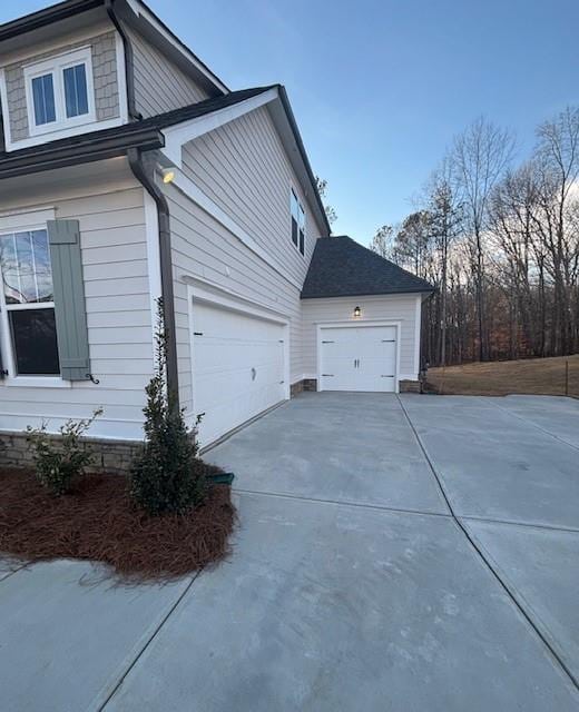 view of side of property with concrete driveway