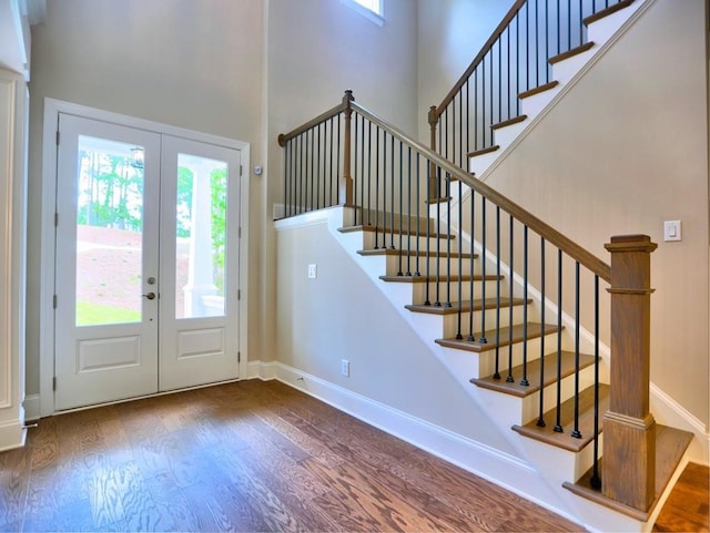 3730 Reserve Overlook Way, Cumming, GA 30041 - entrance foyer with french doors, wood finished floors, a towering ceiling, and baseboards