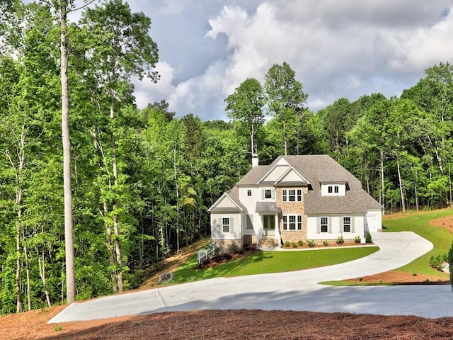 3730 Reserve Overlook Way, Cumming, GA 30041 - view of front facade featuring driveway, a view of trees, and a front yard