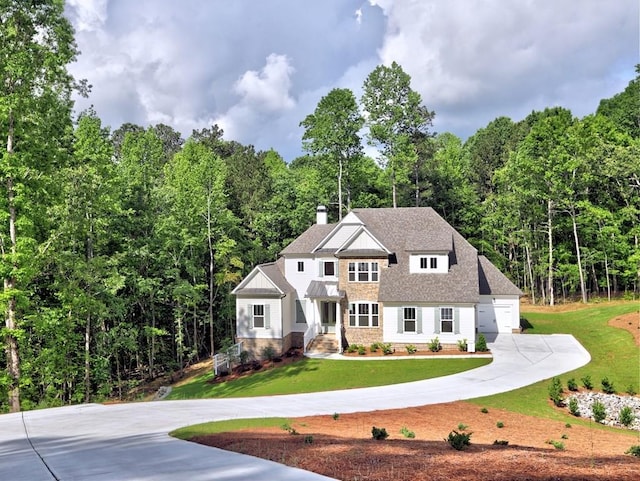 3730 Reserve Overlook Way, Cumming, GA 30041 - view of front of home featuring curved driveway, a front yard, a wooded view, and a chimney