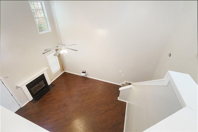 living room featuring ceiling fan and a high ceiling