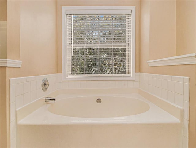 bathroom featuring a bath and a healthy amount of sunlight