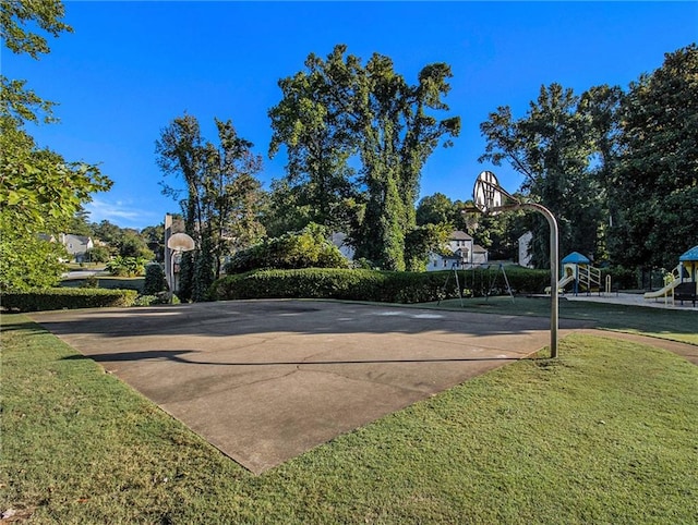 view of sport court with a yard