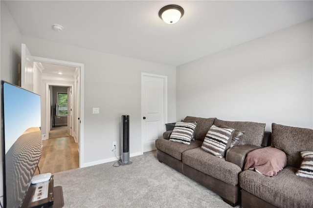 living area with light carpet and baseboards