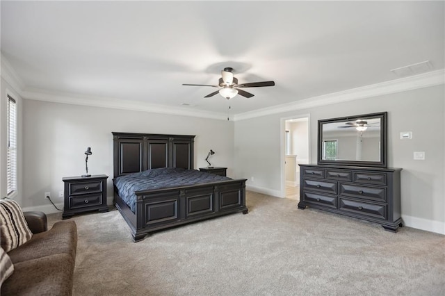 bedroom with light carpet, baseboards, a ceiling fan, ensuite bath, and ornamental molding