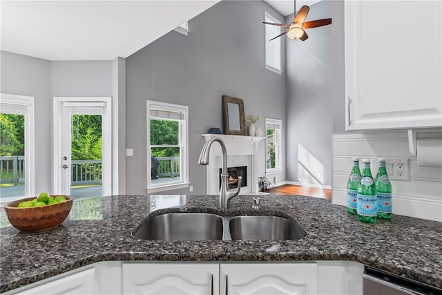 kitchen with plenty of natural light, a sink, and white cabinetry