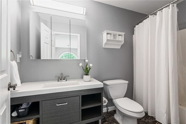 bathroom with vanity, marble finish floor, toilet, baseboards, and a shower with shower curtain