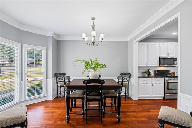 dining area with crown molding, dark wood finished floors, and a chandelier