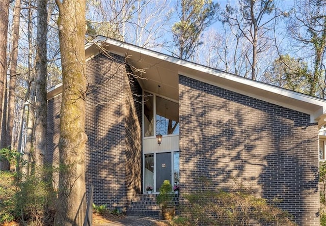 view of side of property with brick siding