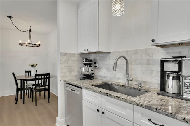 kitchen featuring dishwasher and white cabinets