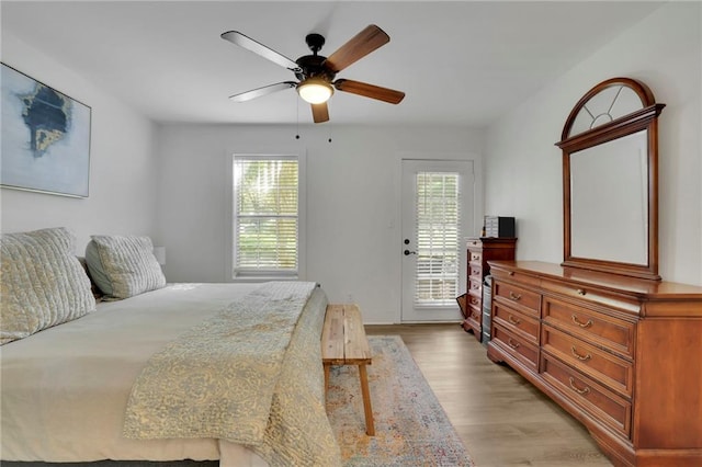 bedroom with ceiling fan, light hardwood / wood-style floors, and access to exterior