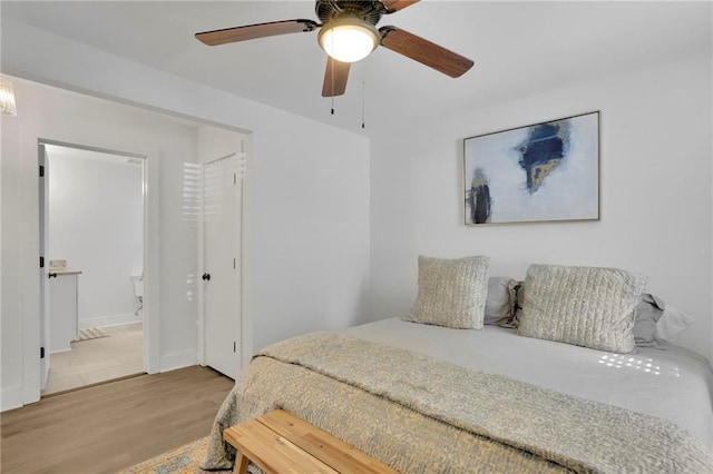 bedroom featuring ceiling fan, ensuite bathroom, and hardwood / wood-style floors