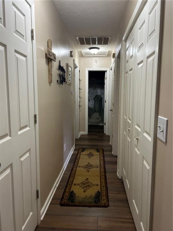 hallway featuring dark hardwood / wood-style flooring