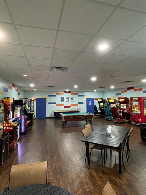 game room with hardwood / wood-style flooring, a paneled ceiling, and pool table