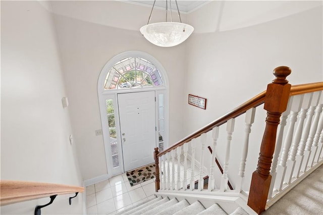 foyer featuring baseboards and tile patterned floors