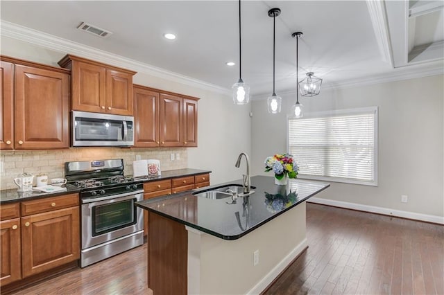 kitchen featuring a sink, ornamental molding, appliances with stainless steel finishes, backsplash, and brown cabinetry