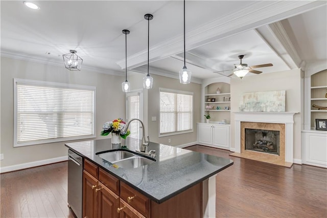 kitchen featuring stainless steel dishwasher, built in shelves, dark wood-style floors, and a sink