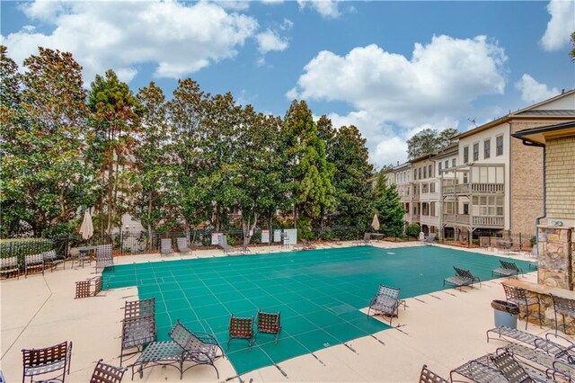 pool featuring fence and a patio