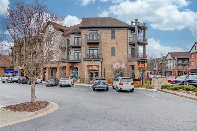 view of property featuring uncovered parking