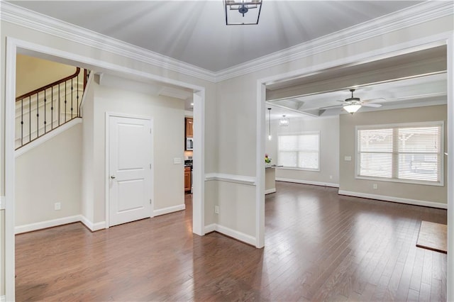 spare room with dark wood-style floors, baseboards, and crown molding