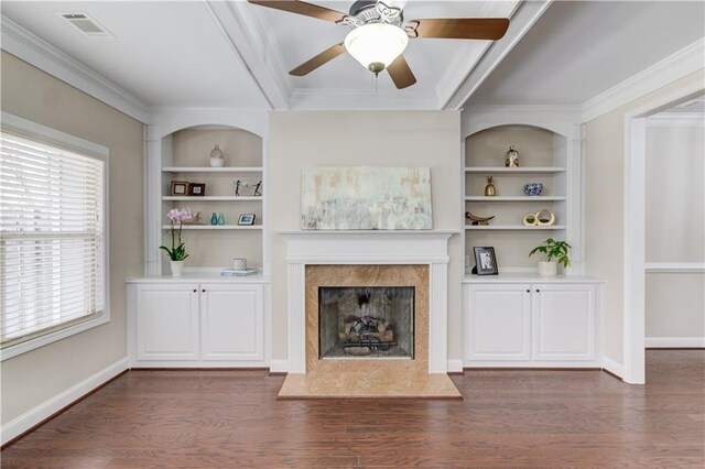 unfurnished living room with ornamental molding, dark wood-type flooring, visible vents, and built in features