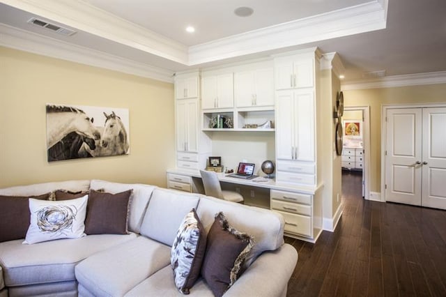 living room featuring dark hardwood / wood-style floors, a raised ceiling, and ornamental molding