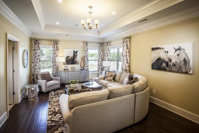 living room featuring a notable chandelier, dark hardwood / wood-style flooring, ornamental molding, and a wealth of natural light