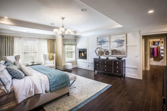 bedroom featuring a chandelier, dark hardwood / wood-style flooring, and crown molding