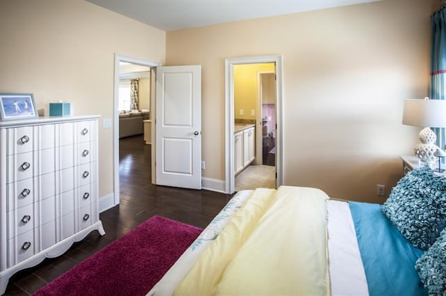 bedroom featuring connected bathroom and dark hardwood / wood-style flooring