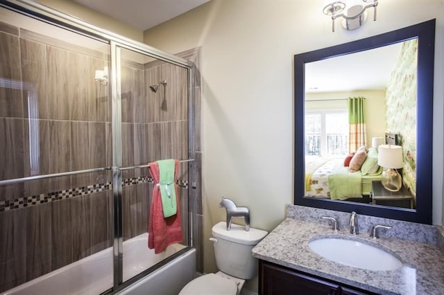 full bathroom with vanity, toilet, and bath / shower combo with glass door