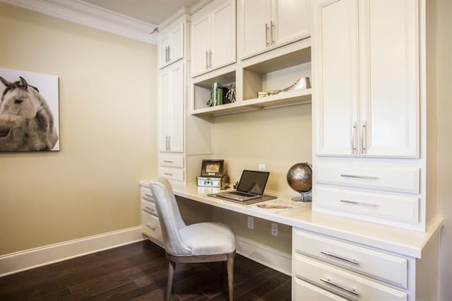 office space featuring dark hardwood / wood-style floors, built in desk, and crown molding