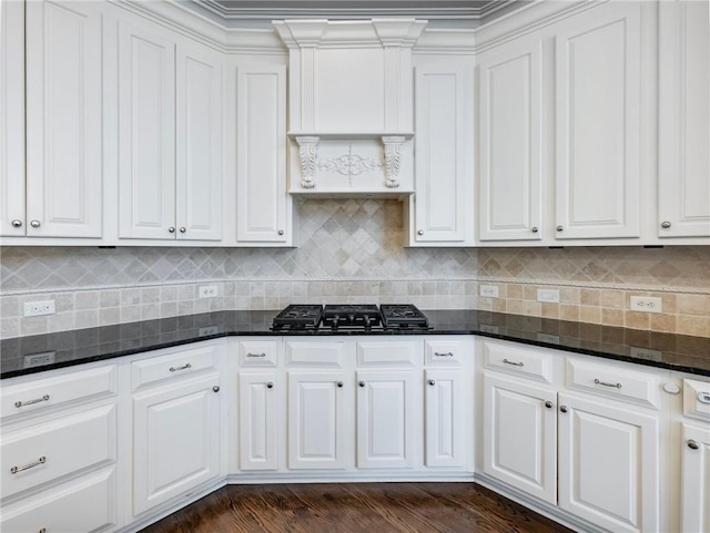 kitchen with dark stone counters, black gas cooktop, and white cabinets