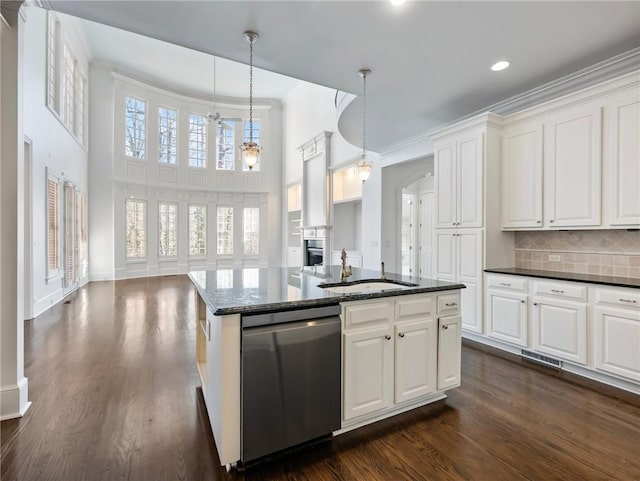 kitchen with decorative backsplash, dishwasher, white cabinets, and decorative light fixtures