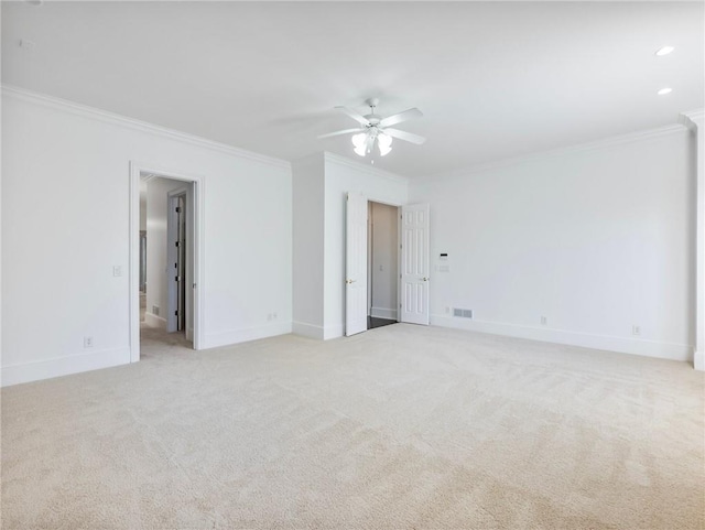 spare room with ornamental molding, light carpet, and ceiling fan