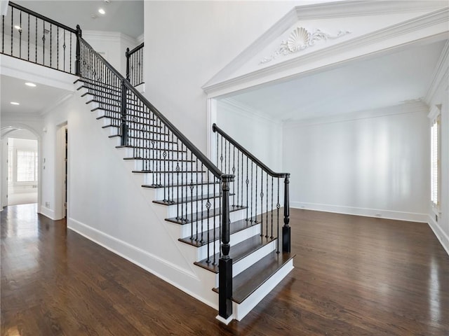 stairs with hardwood / wood-style floors and ornamental molding