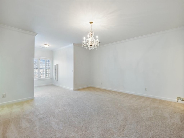 spare room featuring light colored carpet, ornamental molding, and a chandelier