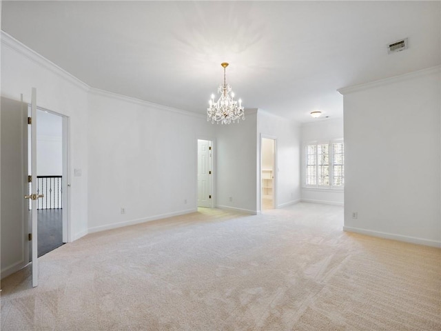 carpeted spare room with ornamental molding and a notable chandelier