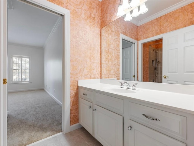 bathroom with crown molding, vanity, and a tile shower