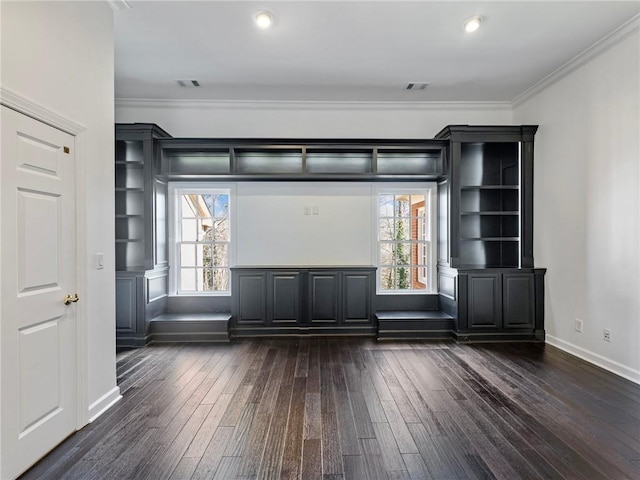 spare room with ornamental molding, plenty of natural light, and dark hardwood / wood-style flooring