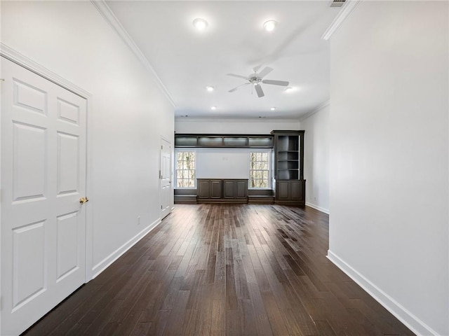 unfurnished living room featuring dark hardwood / wood-style flooring, crown molding, and ceiling fan