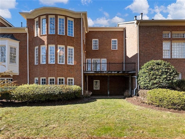 rear view of property with a lawn